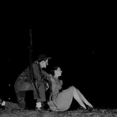 Night photo of a soldier with a girl