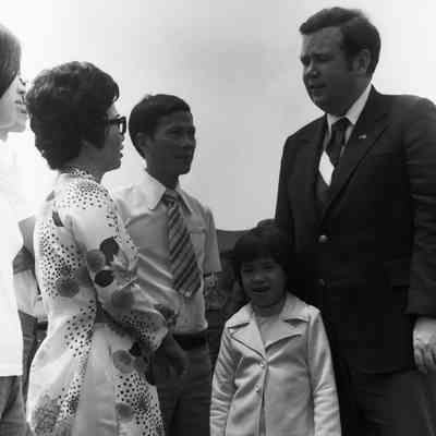Govenor David Boren meeting a refugee family from Vietnam