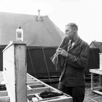 Soldier washing up at a field latrine