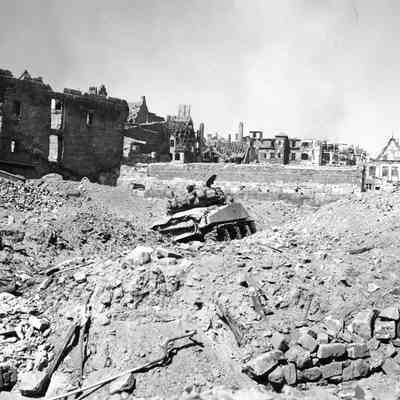 Tank stuck in bomb crater and rubble
