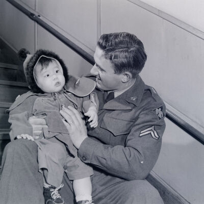 Soldier holding Japanese toddler