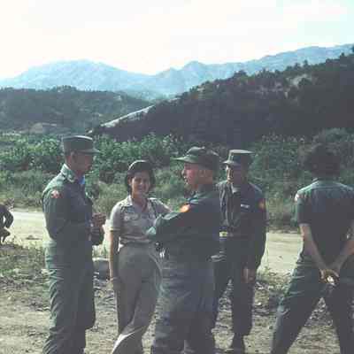 Soldiers talking to two nurses