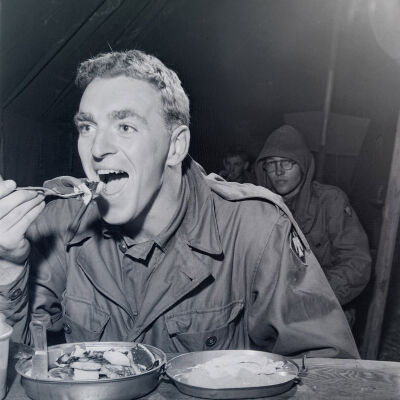 Soldier eating in tent