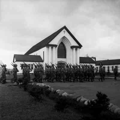 Soldiers marching past Camp Crawford chapel