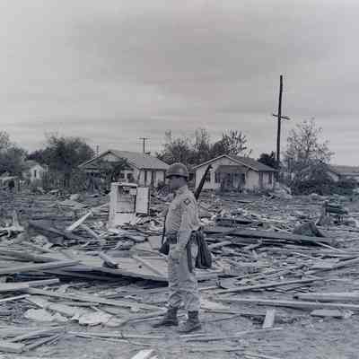 Soldier stands amongst the tornado damage
