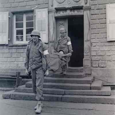 Soldiers carrying soldier on stretcher
