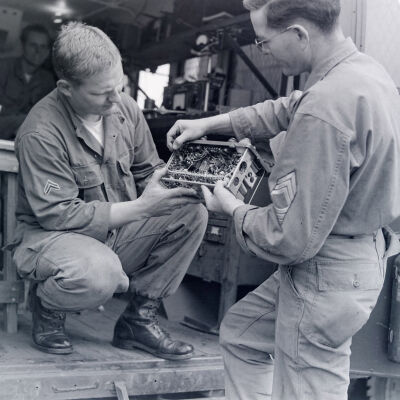 Two soldiers examining an electronic device