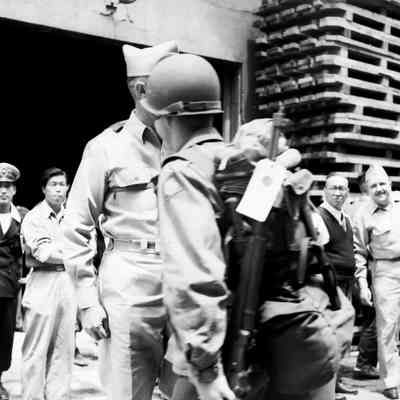 General Styron watching soldiers coming down gangway from ship
