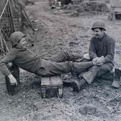 Soldier giving foot rub to another soldier