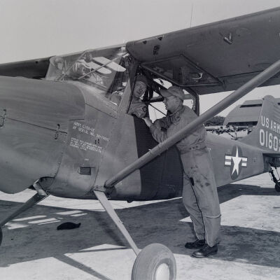 Two soldiers with light aircraft at airstrip