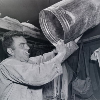 Soldier examining the inside of a 5-gallon can