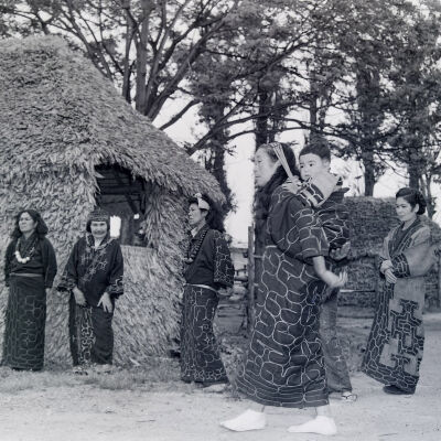 Ainu women and child in native dress