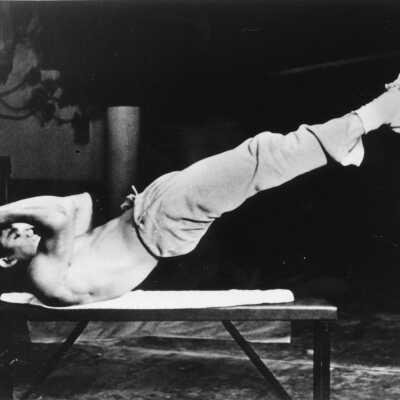 Bruce Lee in Leg Lift Position on Weight Bench