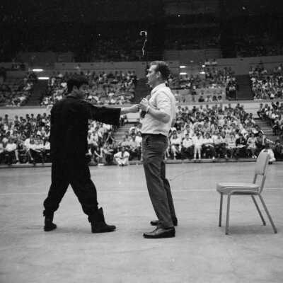 Photograph of Bruce Lee in martial arts demonstration