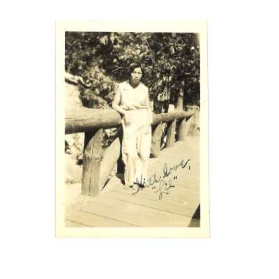 Lily Leong Standing by a Wooden Bridge