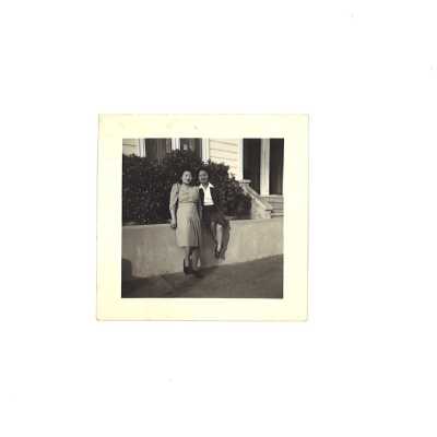 Two Chinese Females in Front of House