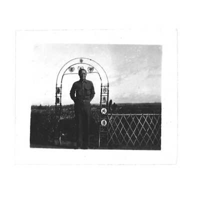 William Hoy Overseas Posing in Front of a Gate with Arch Decorated with Chinese Symbols