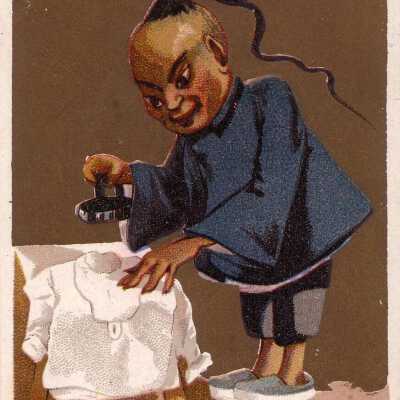 A Chinese Man Irons a White Shirt