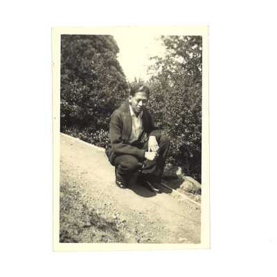A Man Sitting on a Slope Outside
