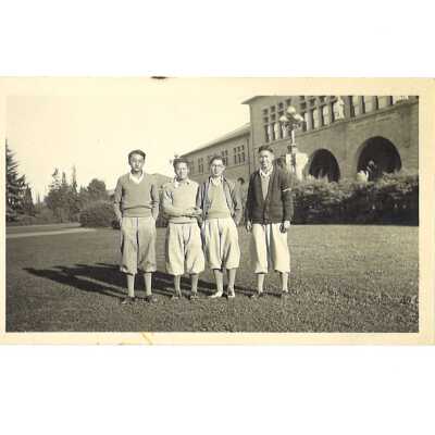 4 Men in Sporting Outfits in Front of an Administration Building