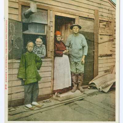 Postcard, family in front of wooden house