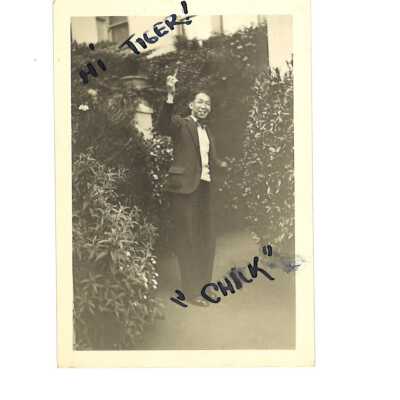 A Man in a Bow tie Holding a Cigar and Waving