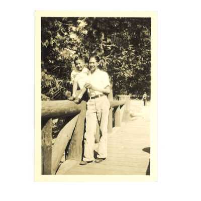 A Man and his Son Posing in Front of a Log Bridge
