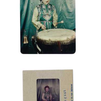 Woman in Blue-Green Costume and Drum