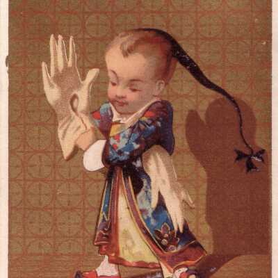A Young Boy Tries On Oversized White Gloves