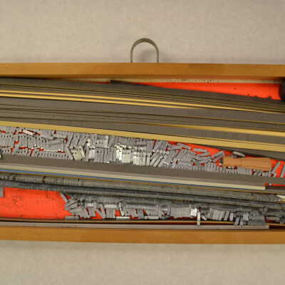 A Box with Metal Type Pieces