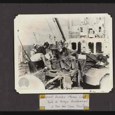 Image of men aboard ship checking machinery to be used on the islands