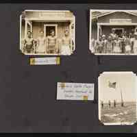 Men on Howland Island in front of the flag pole and "Government House"