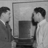 Left - Richard B. Black, representative of the U.S. Dept. of the Interior of Honolulu and Albert Akana Jr., leader of a group of Hawaiian boys who are stationed on Jarvis island to maintain the weather observation station for their country.