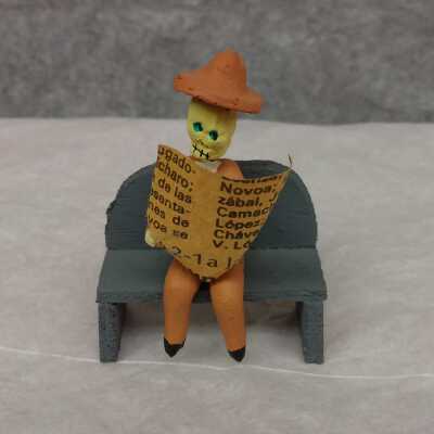 Small Skeleton Man Reading Newspaper on Bench