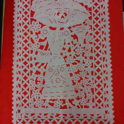 Skeleton woman with hat, fan, and purse surrounded by flowers- Papel picado