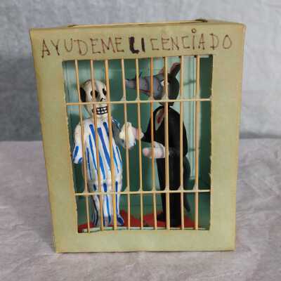 Miniature skeleton and rat in a jail cell
