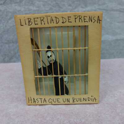 Miniature Grim Reaper in a jail cell