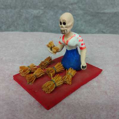 Miniature woman with straw