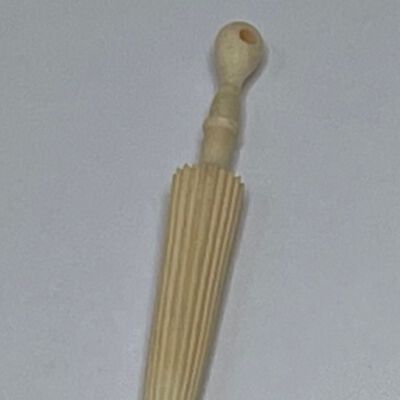 #3: A vegetable ivory carved umbrella that unscrews to reveal a space for storing needles inside the umbrella