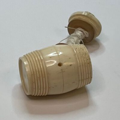 #2: Showing the barrel open with white thread wound round the interior staff