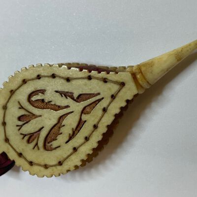 #2: Carved (Bone or ivory) pin keep shaped as a bellows with carved cut outs with red silk showing through. Sandwiched between the hard surface is soft layer of wool covered in red silk. Pins are inserted parallel to the hard surface into the silk.