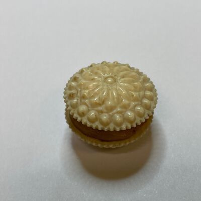 #3: Bone high-relief carved waxer with a floral design. Wax is sandwiched between the two sides