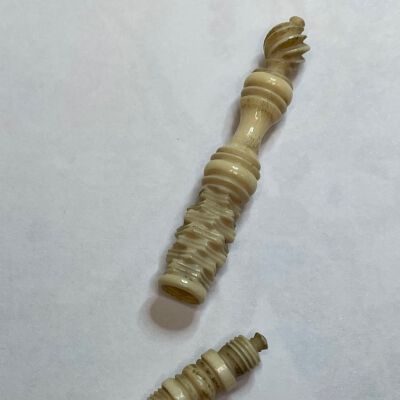 #3: Carved bone with a jenga-type carving on the shaft, followed by ovals and a flame-like top with finial. When closed, the longer shaft closes over the awl and screws shut. when opened, the long shaft screws over the blunt end of the awl to create a handle.
