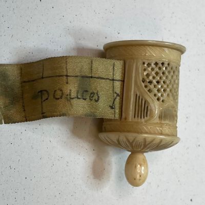 #5: Bone retractable tape measure printed in French POUCES for inches. Carved cylinder with an ecru tape