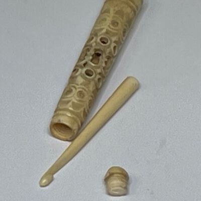 #2: A carved bone crochet hook case with carved bone hook