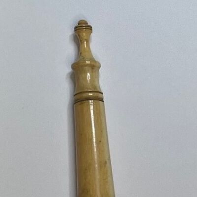 #5: Bone needlecase with a rounded barrel like base and double-tiered screw cap