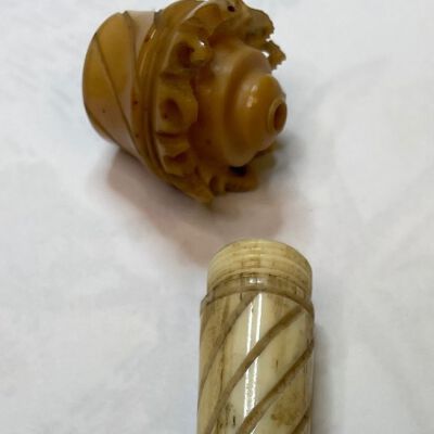 #7: The shaft of the needlecase is carved with barber pole style lines and has a pointer tip, the cap is of nut and has aged to a lovely honey color. The capis flat on the top with barber pole style lines along the sides ending in open circles along the bottom of the cap. The cap screws onto the shaft.