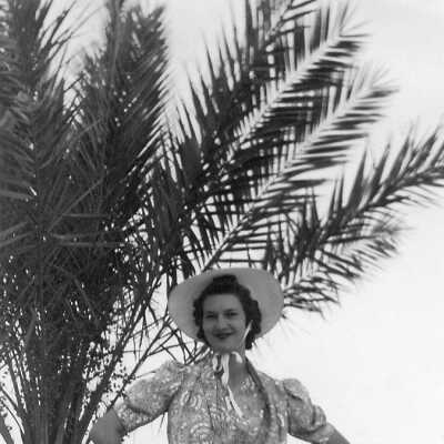 Marjorie posing by the date tree