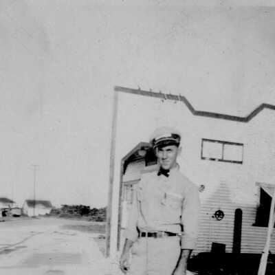 Louis Pellicier in front of gas station, Tavernier