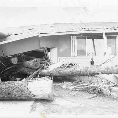 Flood Debris With Logs Rammed into Home